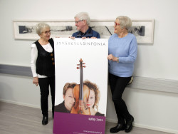 Kolme ihmistä ja Jyväskylä Sinfonian juliste. Kuva Suvi Lindell-Mäkelä